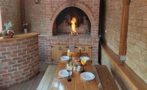 达鲁瓦尔Holiday&wellness house Grofica的砖炉,配有桌子和壁炉
