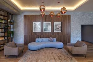 巴库Radisson Hotel Baku的客厅配有蓝色的沙发和两把椅子