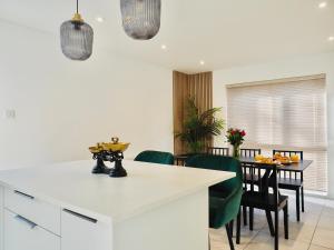 法恩伯勒Luxurious Detached Bungalow with Private Parking的厨房以及带桌椅的用餐室。