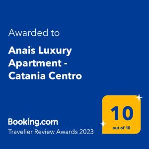 卡塔尼亚Anais Luxury Apartment - Catania Centro的卡塔尼亚中心豪华公寓的黄色标志与动物名词