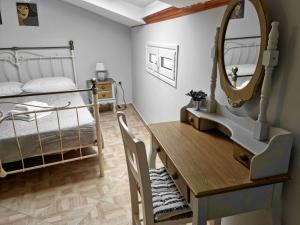 AnemómylosVilla Maxim in Corfu Town的一间卧室配有书桌、一张床和镜子