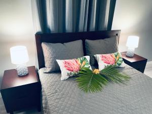 波拉波拉Fare Luna - Comfy New home in Bora Bora的一间卧室配有一张带枕头的床和两盏灯。