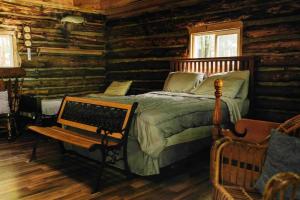 彭延Rustic Ridge的小木屋内一间卧室配有一张床和一张长凳
