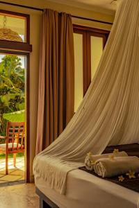 坎古Ecosfera Hotel, Yoga & Spa的一间卧室配有一张带蚊帐的床