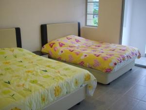 而连突绿叶悦椿家庭酒店的两张睡床彼此相邻,位于一个房间里