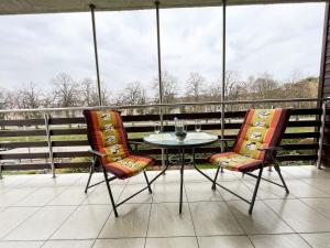 弗瓦迪斯瓦沃沃Apartamenty Jasny Brzeg的阳台配有一张桌子和两把椅子