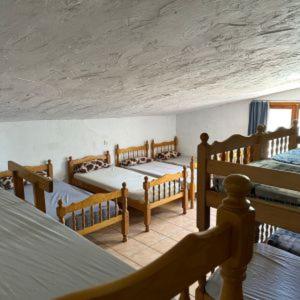 瓦伦西亚Granja El Regajo的一间带四张床的卧室,位于带天花板的房间内