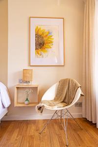 夫罗米斯塔Eco-Hotel Doña Mayor的一间卧室配有椅子和向日葵绘画