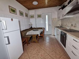 路次亚Pri Noni "IstraCycle"的厨房配有桌子和白色冰箱。