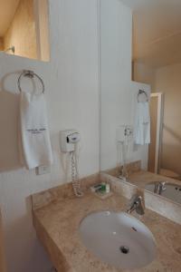莱昂Hoteles Unico Express的一间带水槽和白色手巾的浴室