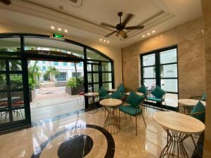 富国Anna Beach Phú Quốc的大堂内的餐厅,配有桌椅