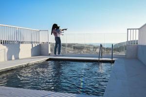 维多利亚Anici Crt Penthouse 4 - with private rooftop pool的站在水库旁的女人