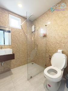 芭堤雅市中心TY假日度假村的浴室配有卫生间、淋浴和盥洗盆。