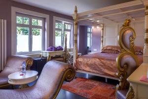 布鲁日Saint Georges Bruges Luxury Suites的卧室配有一张床和一张桌子及椅子