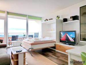 弗赖翁格耶斯堡假日公园酒店的一间卧室配有一张床和一台电视。