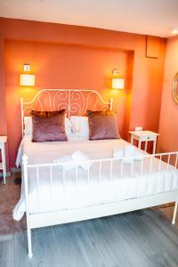 马贝拉Ancha Village的橙色墙壁的房间里一张白色的床