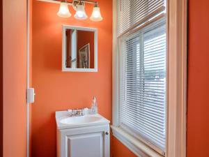 ShamokinShamokin Bed and Breakfast的橙色的浴室设有水槽和窗户。