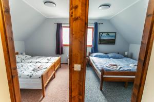 根尼斯迪亚斯LiBe Apartman的一间卧室配有两张床和镜子