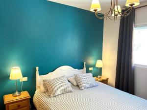 博尔钮乌绿洲拉斯棕榈公寓的一间卧室配有一张蓝色墙壁的床