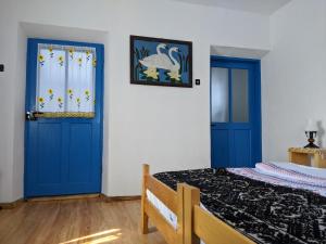 穆里吉奥尔Casa Traditionala Clisciova的一间卧室设有蓝色的门和一张床