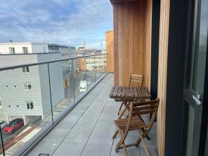 雷克雅未克Iceland SJF Apartments - 503的大楼内的阳台配有木桌和椅子