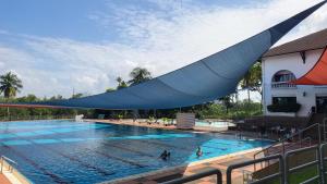 新山庞德尔罗萨高尔夫乡村度假酒店的游泳池上方有一个蓝色的大帆