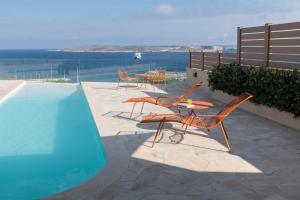 MġarrGozo Harbour Views, Mgarr Heights的游泳池旁带桌椅的天井