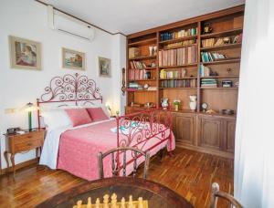 蒙特罗索阿尔马雷Villa Tanca With AC, Terrace and Views的一间卧室设有一张床和一个书架