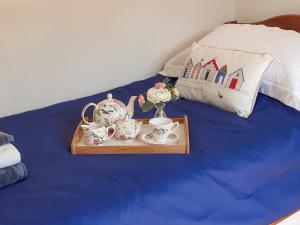伍尔Meadow Barn的床上的茶杯和花瓶托盘