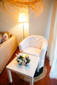 圣维森特-德拉巴尔克拉Apartamentos Costa Norte的客厅配有白色椅子和鲜花桌