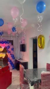 塞得港بورتو سعيد Portosaid的一间设有粉红色和蓝色气球的房间和一张桌子