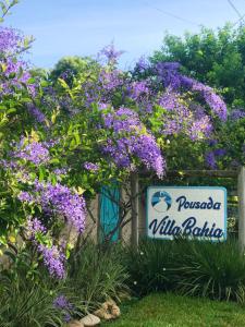 托兰克索Pousada Villa Bahia的紫色花卉花粉别墅标志