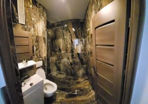 SeleuşRacosim Residentials的一间带卫生间和石墙的浴室