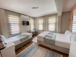 伊斯坦布尔Fidelya Boutique Hotel的一间卧室设有两张床和百叶窗