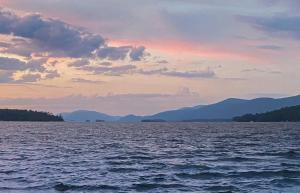 乔治湖Depe Dene Lakeside Resort的日落时分,享有一大片水景