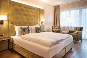 拉布拉Vitalpina Hotel Waldhof的一间卧室配有一张大床和大床头板