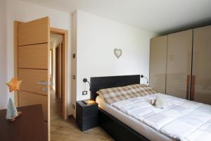 卡瓦莱塞CASA YARA - Dolomiti Affitti的一间卧室配有一张大床和一个木制橱柜
