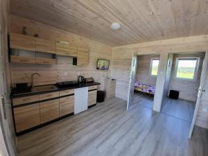 鲁斯诺沃Bajkowe Chatki的厨房设有木墙和木地板