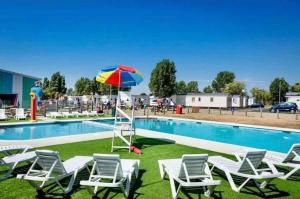 滨海克拉克顿Arizona - Pura Vida Holidays Caravan的游泳池旁设有椅子和遮阳伞