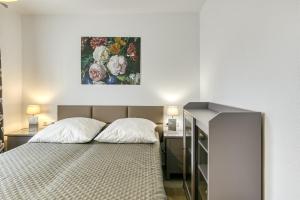 桑特佩尔佩斯卡多尔Casa Elena的卧室配有一张床,墙上挂有绘画作品