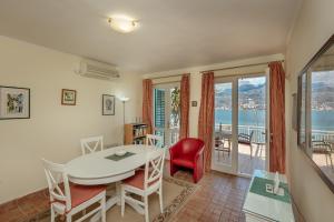 奈维斯Detached Villa with stunning views in Njivice, Montenegro的一间带桌椅的客厅和一个阳台