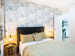 马德里Almar Collection Atocha的一间卧室配有一张带花卉壁纸的床