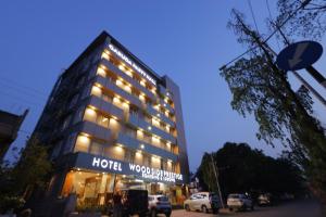 蒂鲁帕蒂Hotel Woodside Prestige的前面有标志的酒店