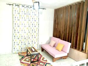 杜阿拉Gêna house的客厅配有粉红色的沙发和椅子