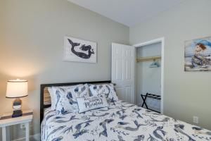 海洋岛海滩Charming Ocean Isle Beach Home about 1 Mi to Beach!的一间卧室配有一张带蓝色和白色棉被的床