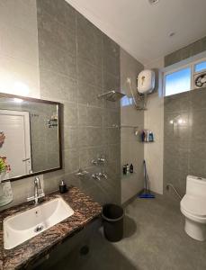 瓦拉纳西Kaashi Flora (Full Villa - 5 Bedrooms)的一间带水槽、卫生间和镜子的浴室