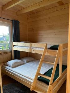 扎托尔Bella Przystań的小木屋内的双层床,设有窗户