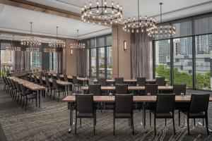 迈阿密AC Hotel By Marriott Miami Brickell的用餐室配有桌椅和大窗户