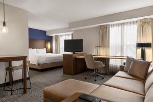 埃克斯顿费城西切斯特/埃克斯顿万豪原住客栈的酒店客房配有一张床、一张沙发和一张书桌。