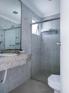塔曼达雷Hotel Coral Beach的浴室配有卫生间、盥洗盆和淋浴。